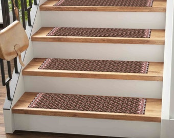 May include: A set of four brown and pink patterned stair treads with a white border. The treads are placed on a wooden staircase with white risers.