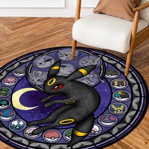 May include: A round, purple and black rug with a stained glass design featuring a black Pokemon character with yellow accents. The character is surrounded by smaller Pokemon characters in a circle.