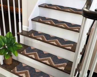 May include: A set of brown and beige chevron patterned stair treads with a textured surface. The treads are placed on a wooden staircase with a white railing.