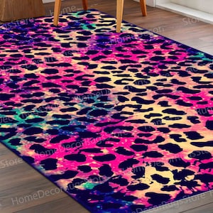 May include: A colorful rug with a leopard print pattern. The rug has a pink, blue, and yellow color scheme with a black leopard print.