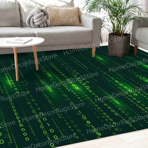 May include: Green and black area rug with a digital pattern of green numbers and lines. The rug is in a living room setting with a white sofa and a coffee table.