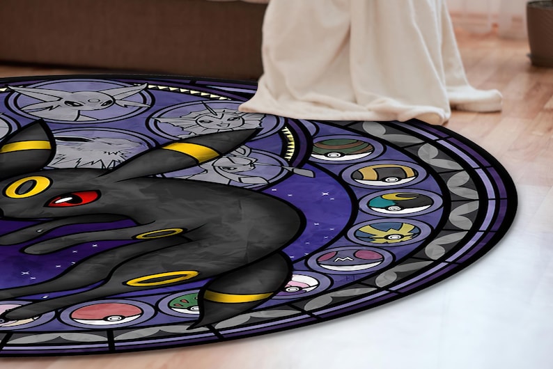 May include: A round, purple and black rug with a stained glass design featuring a black and yellow Pokemon character, surrounded by smaller Pokemon characters in circles.