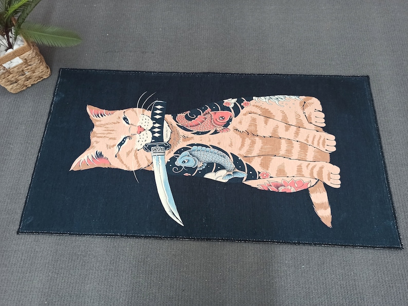 May include: A black and orange cat with a tattoo of a fish and flowers on its body. The cat is holding a silver knife in its mouth.