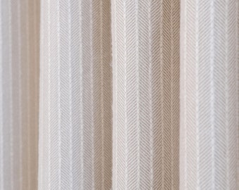 May include: Close-up of beige fabric curtains with a vertical herringbone pattern. The fabric has a textured appearance, with subtle variations in color and tone. The curtains are slightly draped, creating soft folds and shadows.