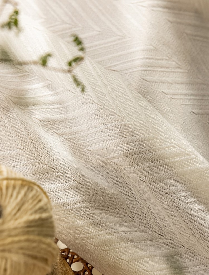 May include: White sheer curtain fabric with a subtle chevron pattern. The fabric is lightweight and has a soft, drapey texture.