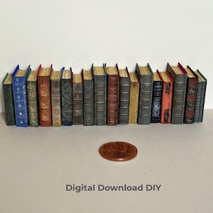 May include: A row of eighteen miniature books with varied colored spines including blue, red, green, and brown, arranged side-by-side. A single copper-colored penny is placed in front of the books for scale. The text Digital Download DIY is visible.