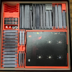 May include: A red and black organizer for a board game. The organizer has compartments for cards, dice, and other game pieces. The organizer is labeled "Saved Campaign", "Ruins", and "Darkest".