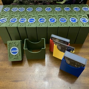 Op de afbeelding: Een set van 20 groene kaartenboxen met blauwe en witte nummers op de voorkant. Er zijn ook vier kaarthouders in rood, geel en blauw met transparante kunststof inzetstukken.