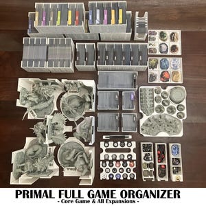 May include: A white game organizer with multiple compartments, holding cards, game pieces, and miniature figures. The text "PRIMAL FULL GAME ORGANIZER" is displayed at the bottom, with "Core Game & All Expansions" below it.