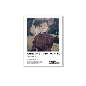 May include: A book titled Pure Inspiration #2 Colour by Malin Fabbri, featuring a portrait of a person wearing a wide-brimmed hat and a dark textured blouse. The cover includes the text Techniques and insights from Artists Working in Alternative Photographic Processes and the Alternative Photography logo.