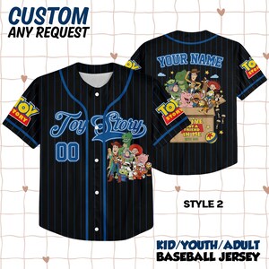 May include: A black baseball jersey with blue pinstripes, featuring Toy Story character graphics, the text Toy Story, 00, Your Name, and You've Got A Friend In Me. The shirt has a button-down front, short sleeves, and Toy Story logos on the sleeves.