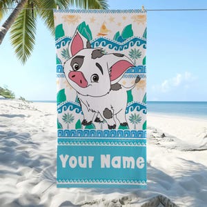 May include: A beach towel featuring a cartoon pig character with a white body, black spots, and pink ears. The towel has a blue border with the text "Your Name" and a pattern of waves, palm trees, and mountains.