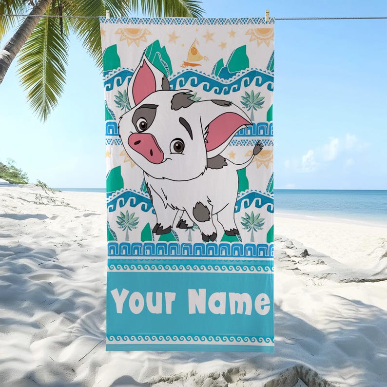May include: A beach towel featuring a cartoon pig character with a white body, black spots, and pink ears. The towel has a blue border with the text "Your Name" and a pattern of waves, palm trees, and mountains.