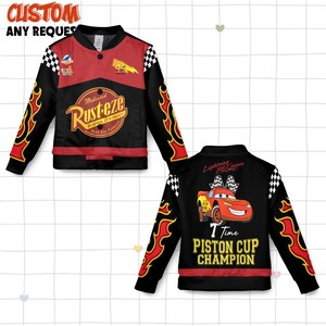 May include: Black and red bomber jacket with flame designs on the sleeves. The front features the text "Rusteze" and the number "95". The back displays a cartoon car and the text "7 Time Piston Cup Champion".