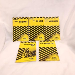 May include: A collection of Cliffs Notes study guides. The covers are yellow with black diagonal stripes. Titles include "Don Quixote," "The Aeneid," "Doctor Faustus," "Henry IV Part I," and "Paradise Lost." Each guide features a mountain graphic.