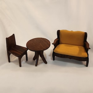 May include: A miniature wooden furniture set with a dark brown finish. The set includes a small table, a chair, and a loveseat with a yellow fabric cushion.