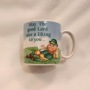 May include: A set of three ceramic mugs with a speckled, matte finish. The mugs are in shades of cream, light gray, and dark gray. Each mug has a simple, minimalist design, perfect for coffee or tea.