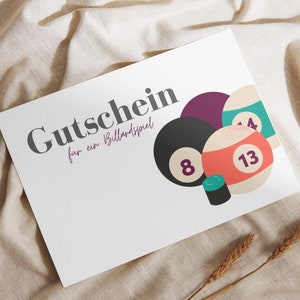 May include: A white gift certificate with the text "Gutschein für ein Billardspiel" and a graphic of billiard balls, including a black ball with the number 8, a red ball with the number 13, and a green ball with the number 14.