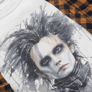 May include: A watercolor illustration of a man with black hair and a white face with blue and gray markings. He is wearing a black leather jacket with a silver collar and a silver belt. The background is white with gray and blue watercolor splatters.