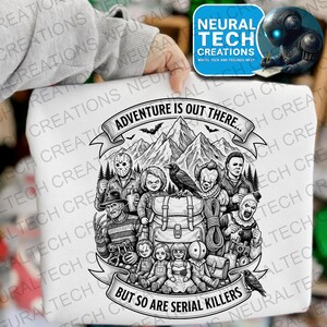 May include: White graphic t-shirt featuring a black and white illustration of various horror movie characters, a backpack, and a mountain range. The text reads "ADVENTURE IS OUT THERE... BUT SO ARE SERIAL KILLERS."