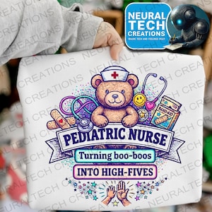 May include: White t-shirt featuring a teddy bear wearing a nurse's hat, surrounded by medical tools and the text "Pediatric Nurse". The design includes a stethoscope, band-aids, and the phrase "Turning boo-boos into high-fives".
