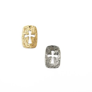 May include: Two metal cross charms, one gold and one silver, with a textured finish. Both charms have a cutout cross design.