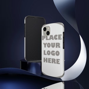 May include: White phone case with a black border and a camera lens. The case has the text "PLACE YOUR LOGO HERE" printed on it.