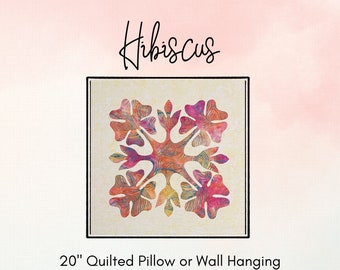 May include: A 20-inch quilted pillow or wall hanging pattern featuring a hibiscus flower design in shades of red, orange, and yellow. The pattern is titled "Hibiscus" and is by Kim Oleson. The pattern is available from Quiltaholics Anonymous.