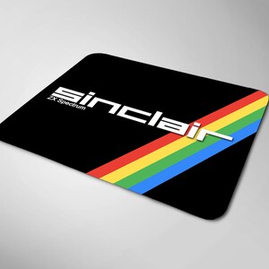 May include: Black mousepad with a rainbow stripe and the text "Sinclair ZX Spectrum" in white.