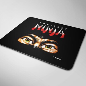 May include: Black mousepad with a red and white graphic of a ninja's eyes and the text "THE LAST NINJA -YUKESH-"