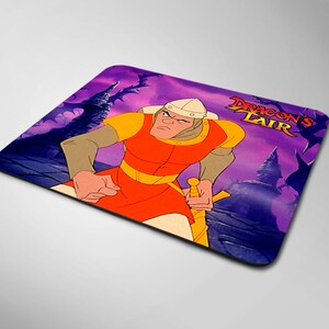 May include: A purple and black mousepad with a cartoon image of a knight holding a sword. The text "Dragon's Lair" is printed in red and yellow on the mousepad.