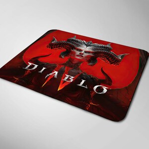 May include: A red and black mousepad with a graphic of a demon woman with horns and the word "DIABLO" in white letters.
