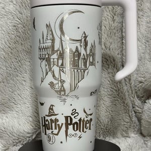 May include: A set of three ceramic mugs with a speckled, matte finish. The mugs are in shades of cream, light gray, and dark gray. Each mug has a simple, minimalist design, perfect for coffee or tea.