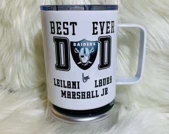 May include: White travel mug with a black and white design that says "Best Ever Dad" with a Raiders logo and the names "Leilani & Laura Marshall Jr."