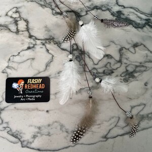 Feather Extension Hair Clip with white spotted feathers and sparkly beads