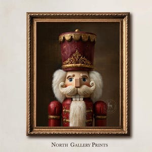 May include: A framed wall art print featuring a portrait of a nutcracker wearing a deep red uniform with gold accents and a tall matching hat. The nutcracker has a white mustache and beard, and the text North Gallery Prints appears below.