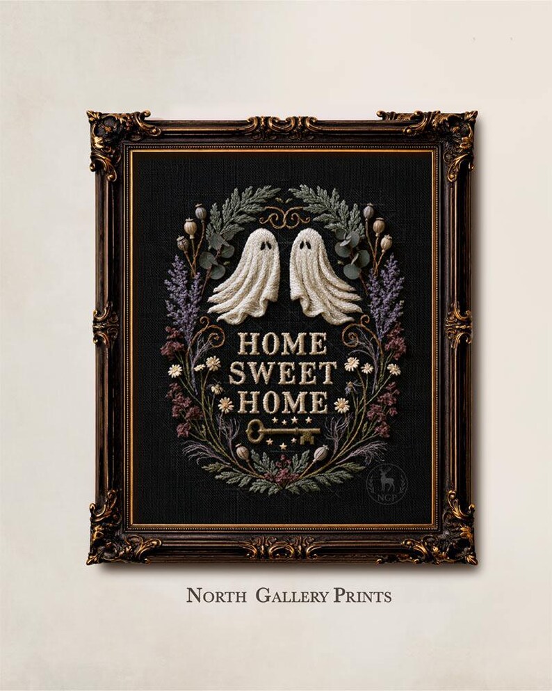 May include: A framed embroidery art piece on black fabric featuring two white ghosts, a floral wreath, and the text HOME SWEET HOME above a key. The ornate dark brown frame has gold accents. The text NORTH GALLERY PRINTS appears below the frame.