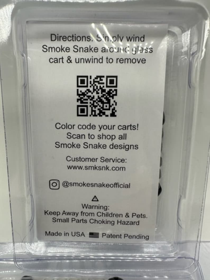 May include: A white card with black text and a QR code. The text reads: "Directions. Simply wind Smoke Snake around glass cart & unwind to remove. Color code your carts! Scan to shop all Smoke Snake designs. Customer Service: www.smksnk.com @smokesnakeofficial Warning: Keep Away from Children & Pets. Small Parts Choking Hazard. Made in USA Patent Pending."