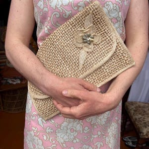 Woven straw clutch bag shell motif