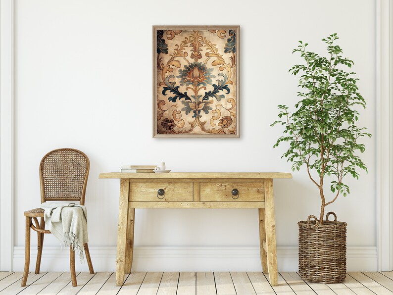 May include: A framed print of a vintage floral pattern in shades of brown, gold, and blue. The print is hanging on a white wall above a wooden console table.