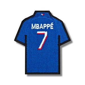 May include: Blue soccer jersey with the name "MBAPPÉ" and the number "7" on the back.