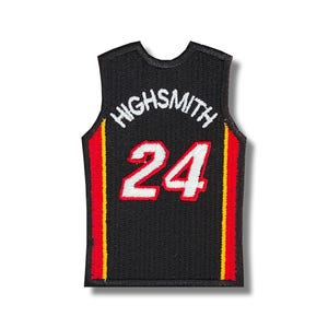 Peut inclure: Maillot de basket-ball noir avec des bordures rouges et jaunes. Le maillot porte le texte "HIGHSMITH" et le numéro "24" en blanc.