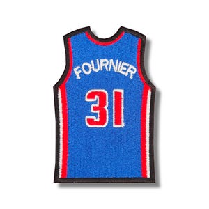 May include: Blue basketball jersey with red and white trim. The jersey has the name "FOURNIER" and the number "31" on the back.