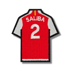 May include: Red and white embroidered football jersey patch with the name "SALIBA" and the number "2" on the back.