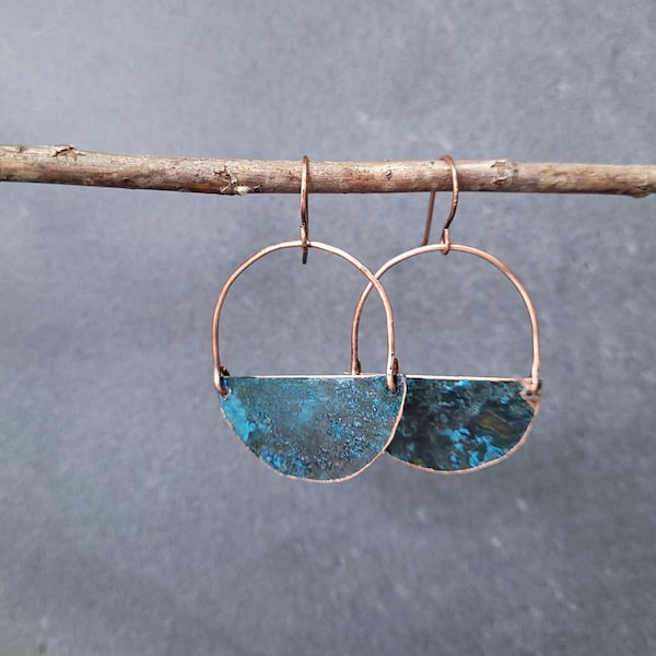 Handmade copper earrings with turquoise patina creating rustic aesthetic