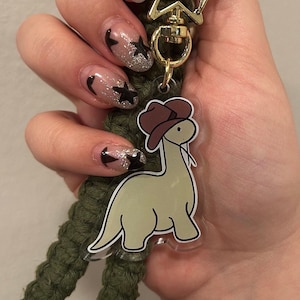 dinosaur wearing a cowboy hat keychain, cowboy keychain, dinosaur, cute, funny, adorable, kawaii, acrylic keychain