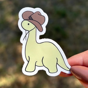 dinosaur wearing a cowboy hat sticker, cowboy sticker, dinosaur sticker, cute sticker, funny sticker, adorable, kawaii sticker, waterproof
