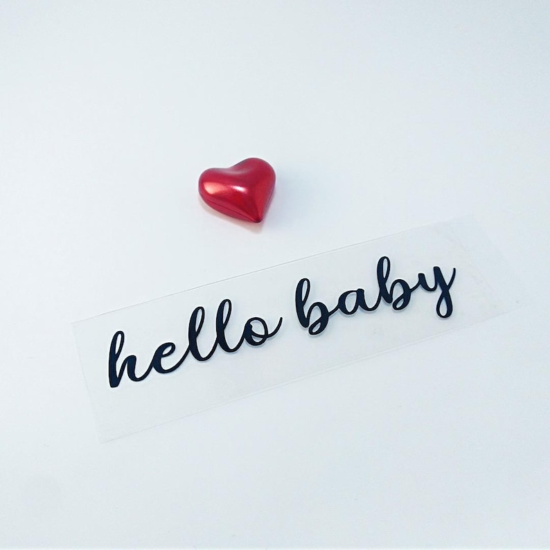 iron on transfer decal with the text hello baby write on black