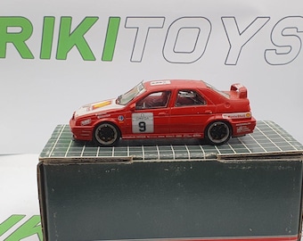 May include: Red 1/18 scale diecast model car of an Alfa Romeo 155 V6 TI, with "Omega" and "9" on the side, and "Mobil Shell" on the back.
