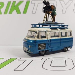 May include: A blue and white toy van with a white roof and a camera on top. The van has a sign on the side that says "Samuelson Film Service Limited".